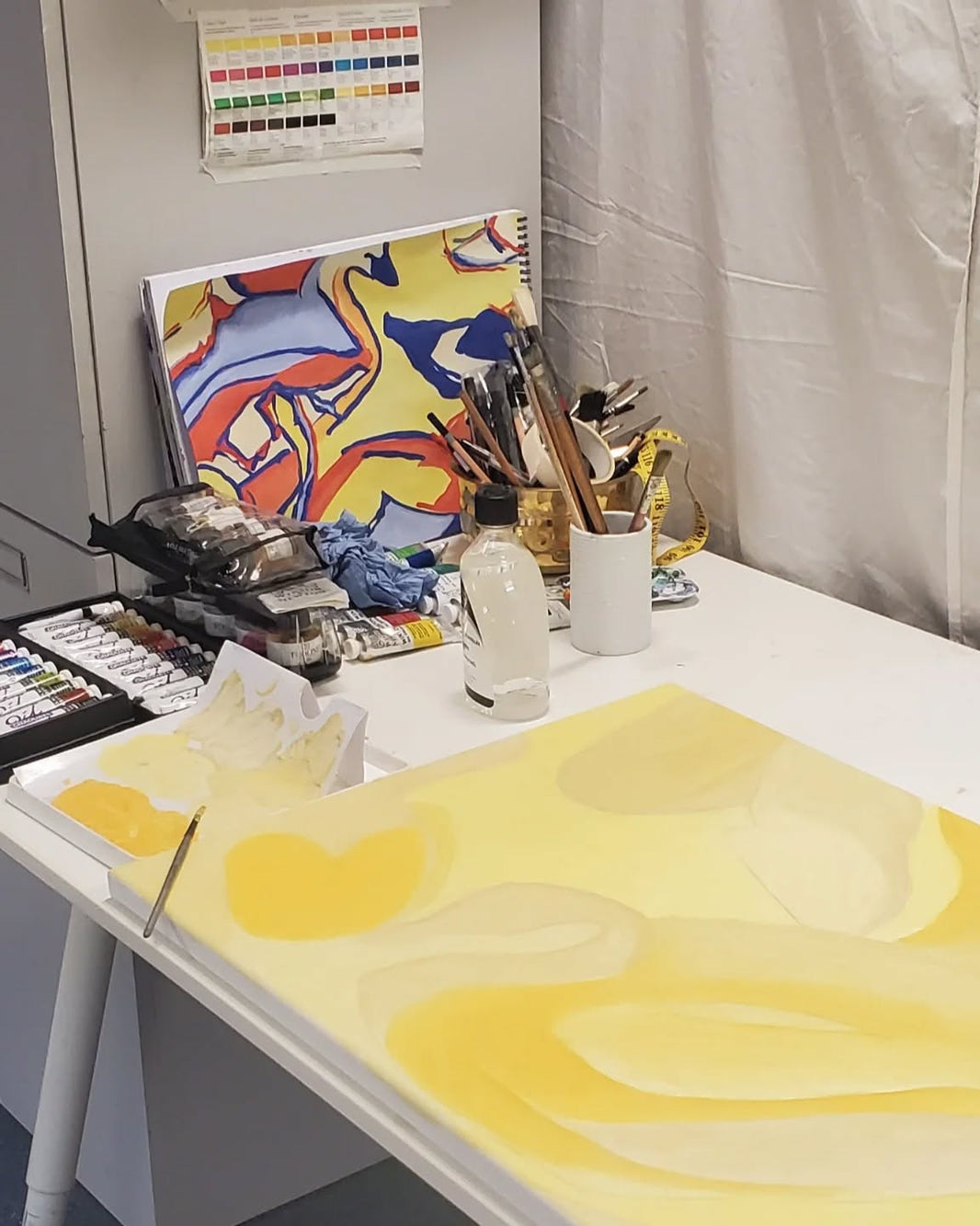 Yellow abstract painting in artist’s studio.